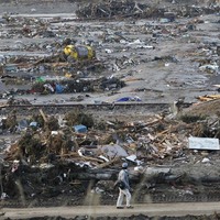 A man walks through the devastation at Rikuzentakata.