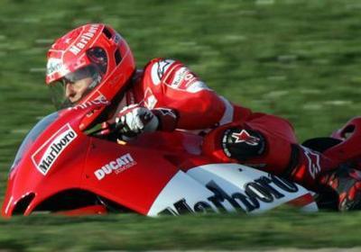 Schumacher failing to imitate Rossi on Capirossi's bike