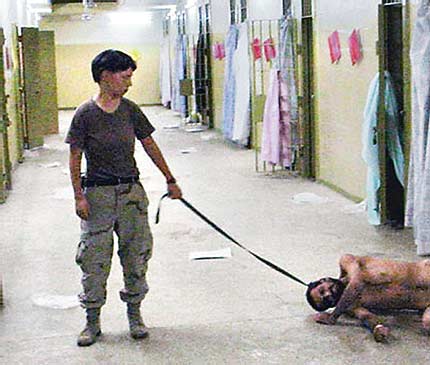 A US soldier humiliating an Iraq prisoner