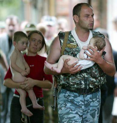 Commando saving a child during the hostage crisis standout in Beslan (Russia)