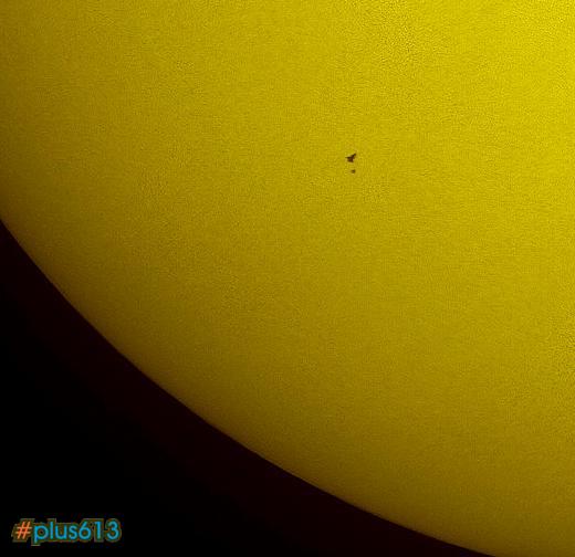 Space Shuttle Atlantis and Hubble Space Telescope pass infront of the Sun
