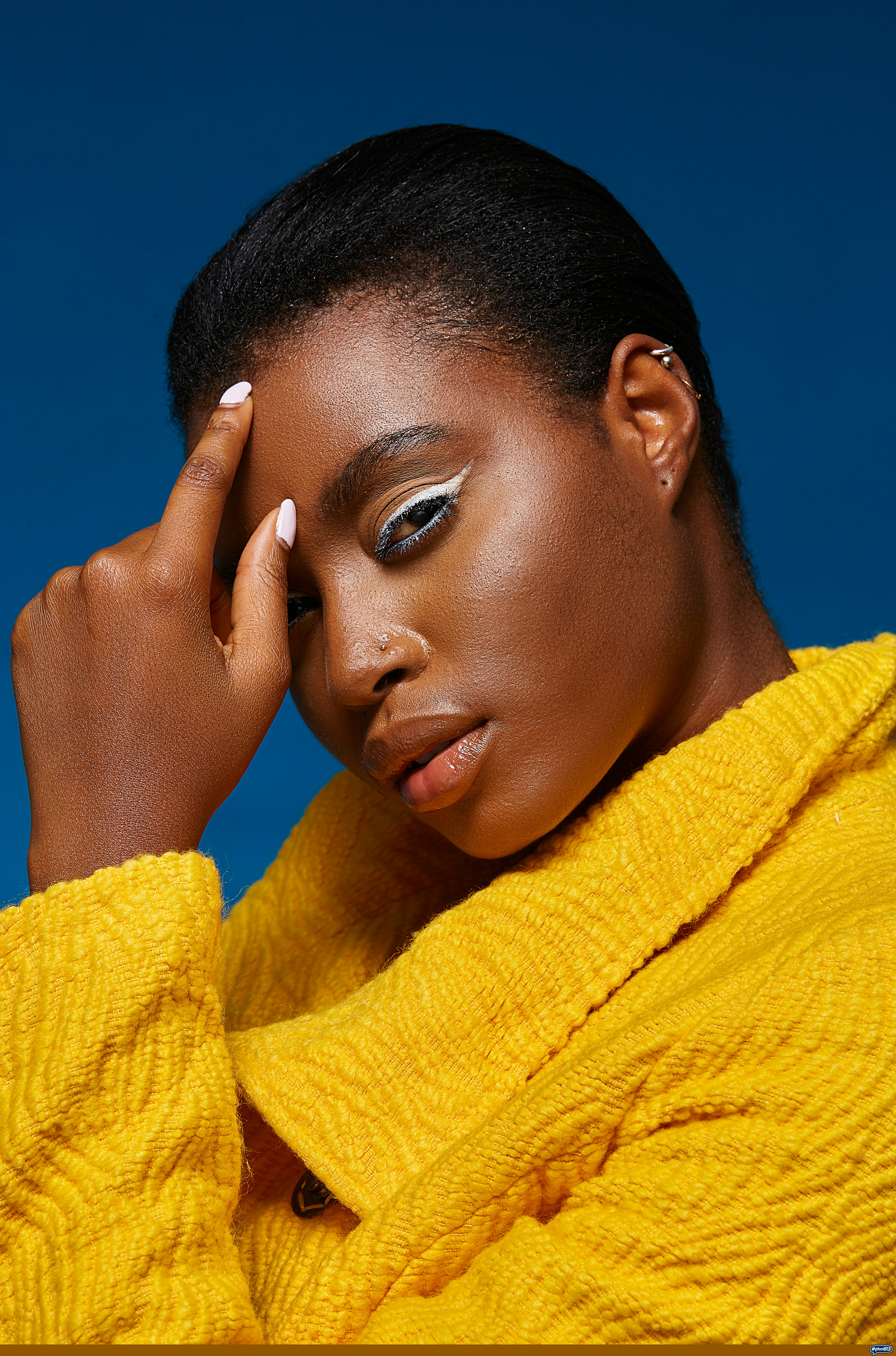 Woman with white eyeliner and yellow jacket by marcus pobee