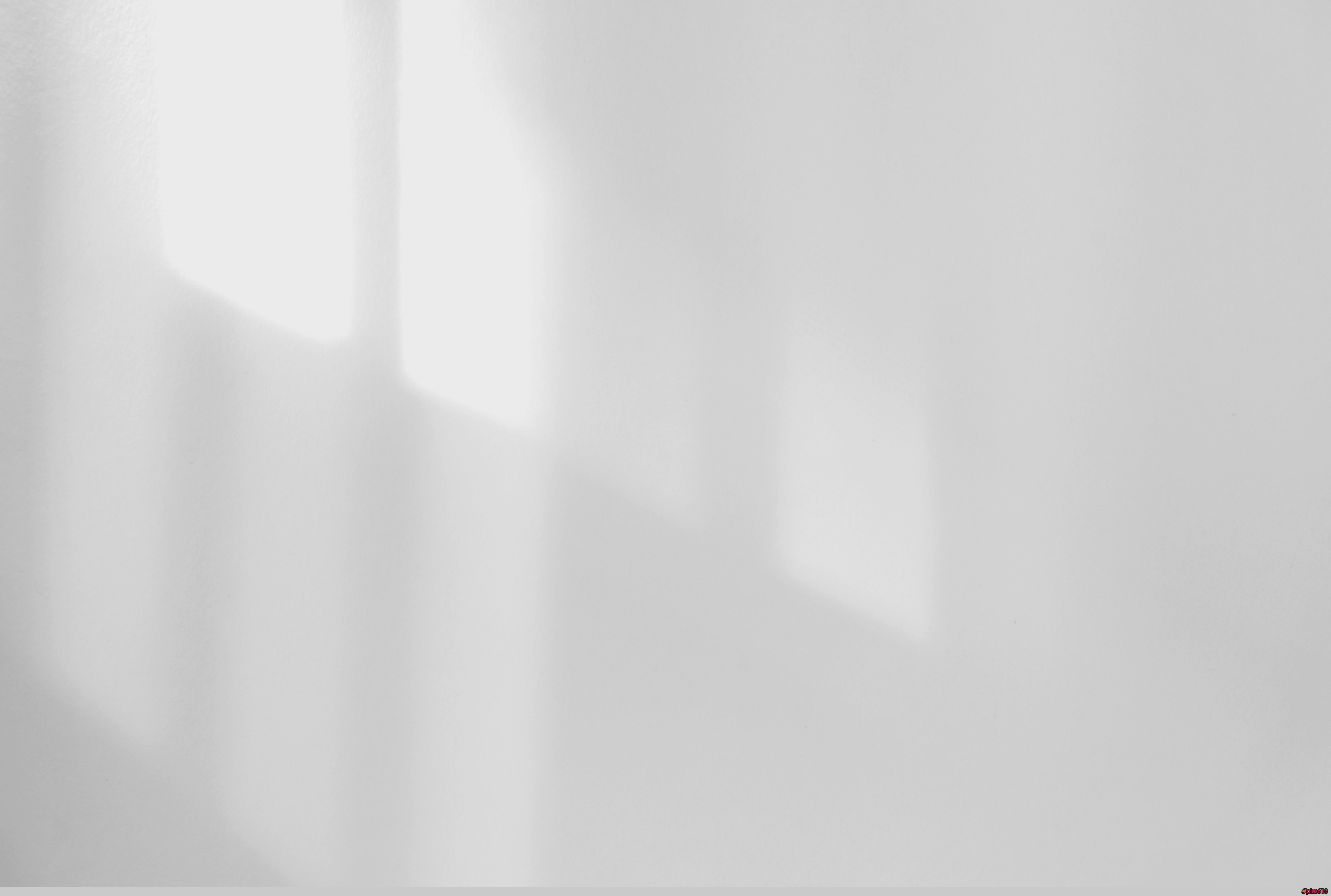 a black and white photo of a white wall by H&CO