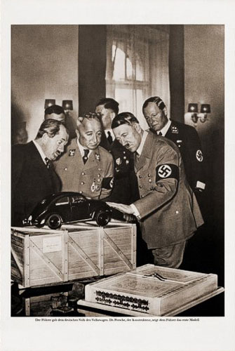 Ferdinand Porsche and Adolf with first model of Beetle, made by sketch of Hitler