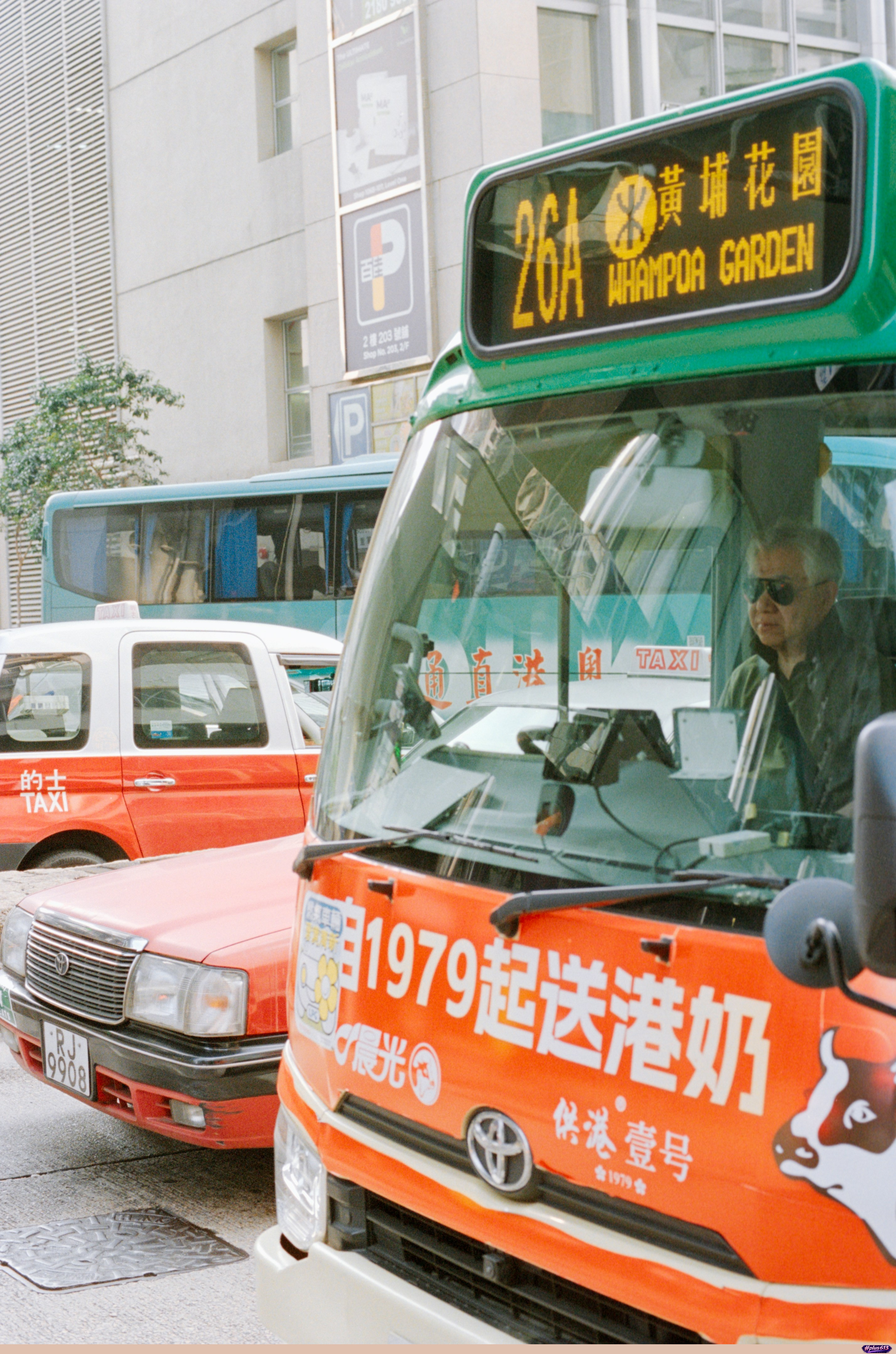 Bus driver behind the wheel in a city street by Zhen Yao