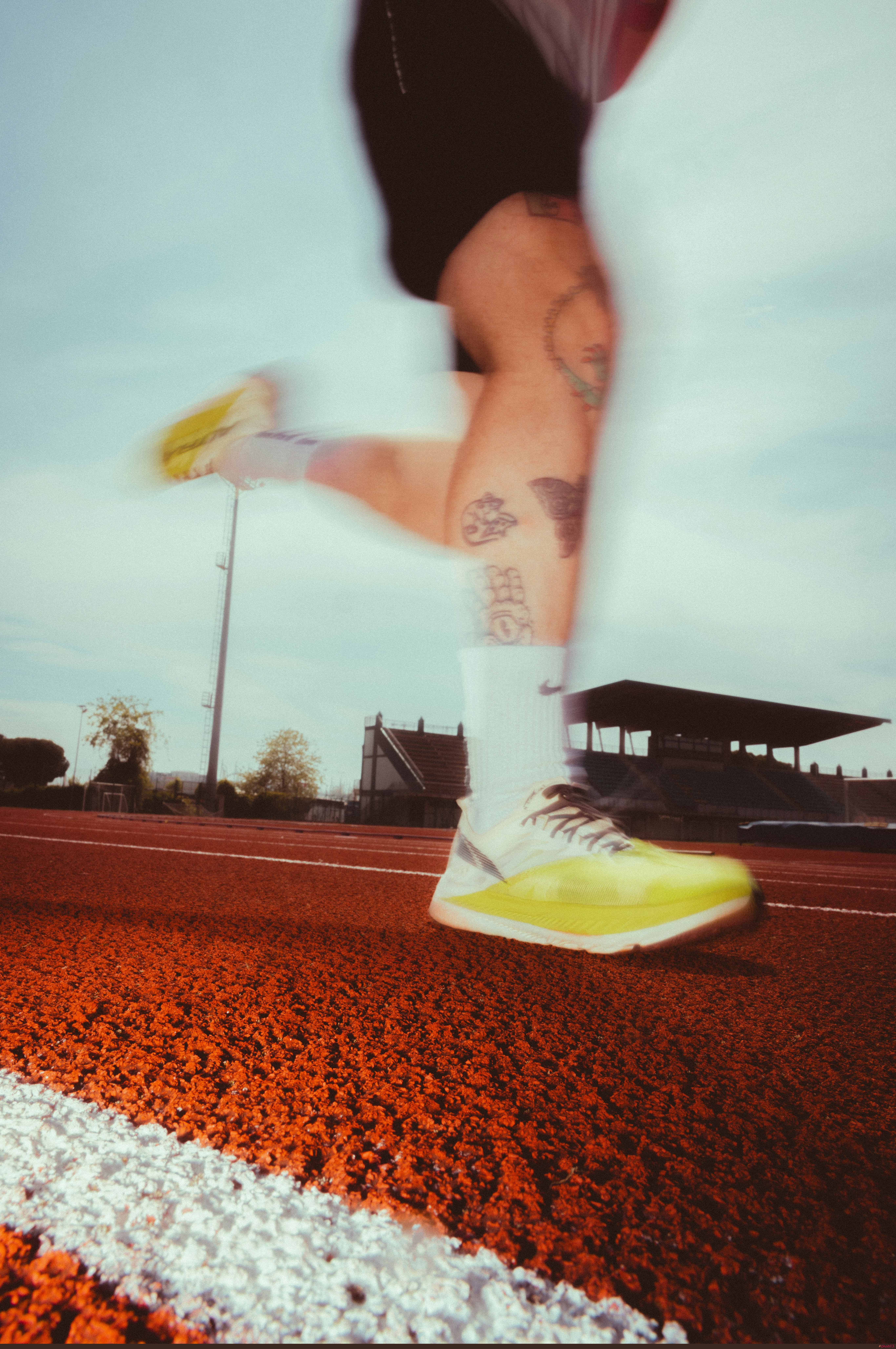 Runner's legs in motion on a track by Kenny Leys