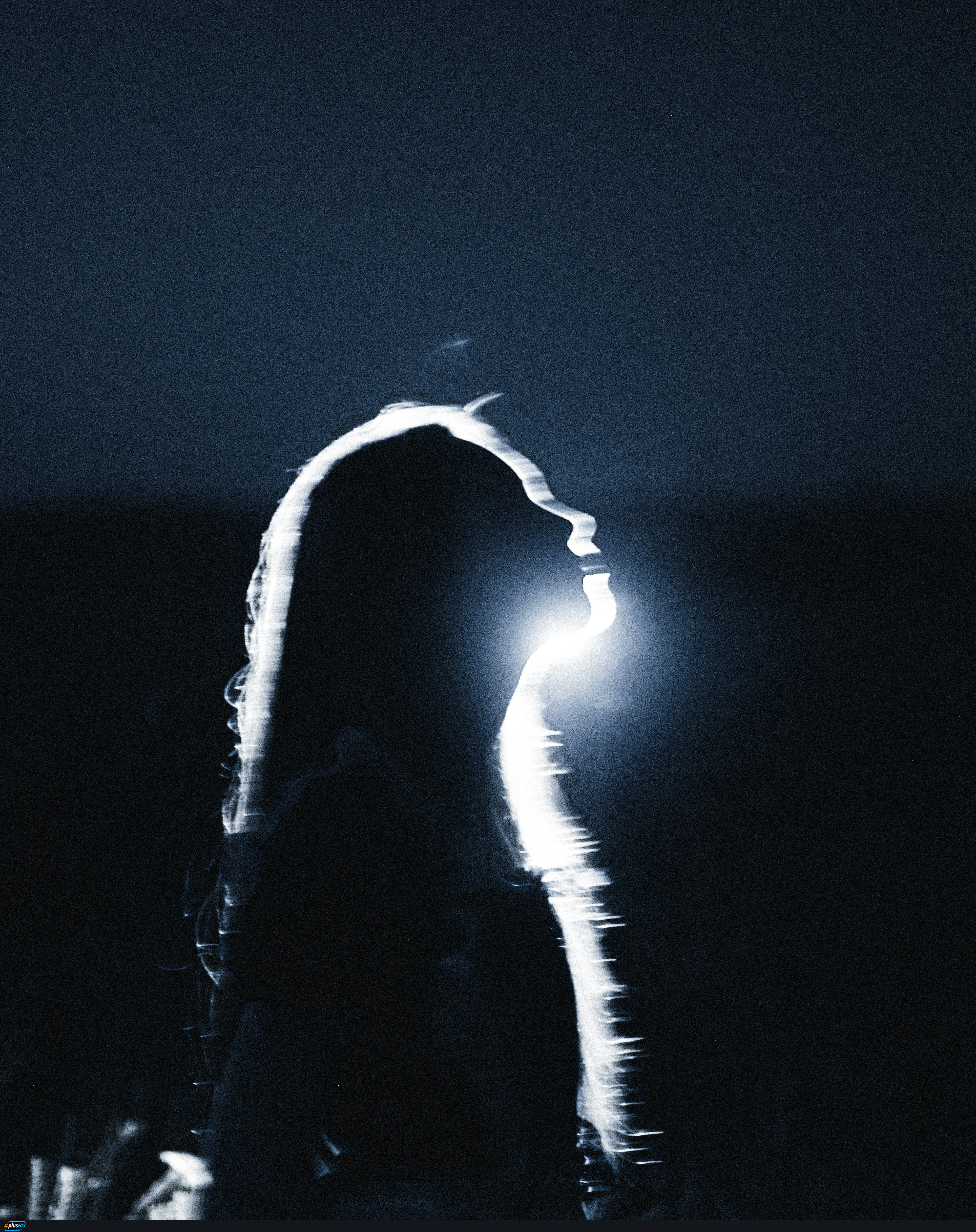 A silhouette of a person with long hair against a bright light source by Max Ovcharenko