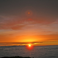 Sun setting into the clouds below Mt.Teide Spain