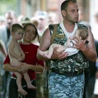 Commando saving a child during the hostage crisis standout in Beslan (Russia)