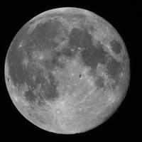 The International Space Station pictured in front of the Moon.