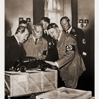 Ferdinand Porsche and Adolf with first model of Beetle, made by sketch of Hitler